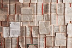 Photograph of book pages pinned to a wall