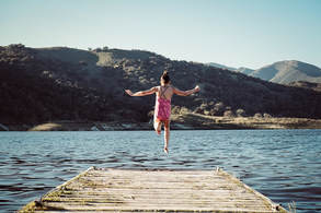 Photograph of person leaping into water